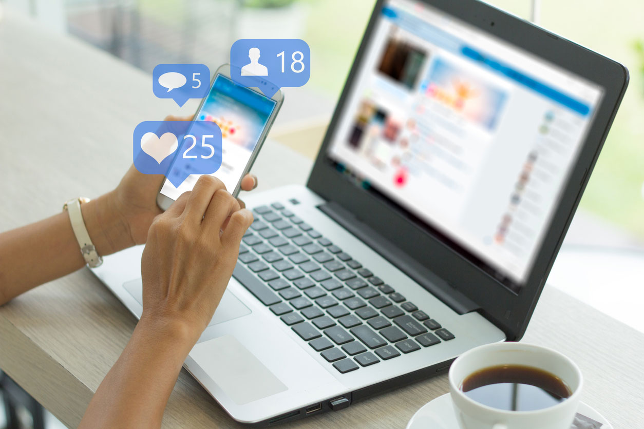 Person holding a mobile phone using Facebook